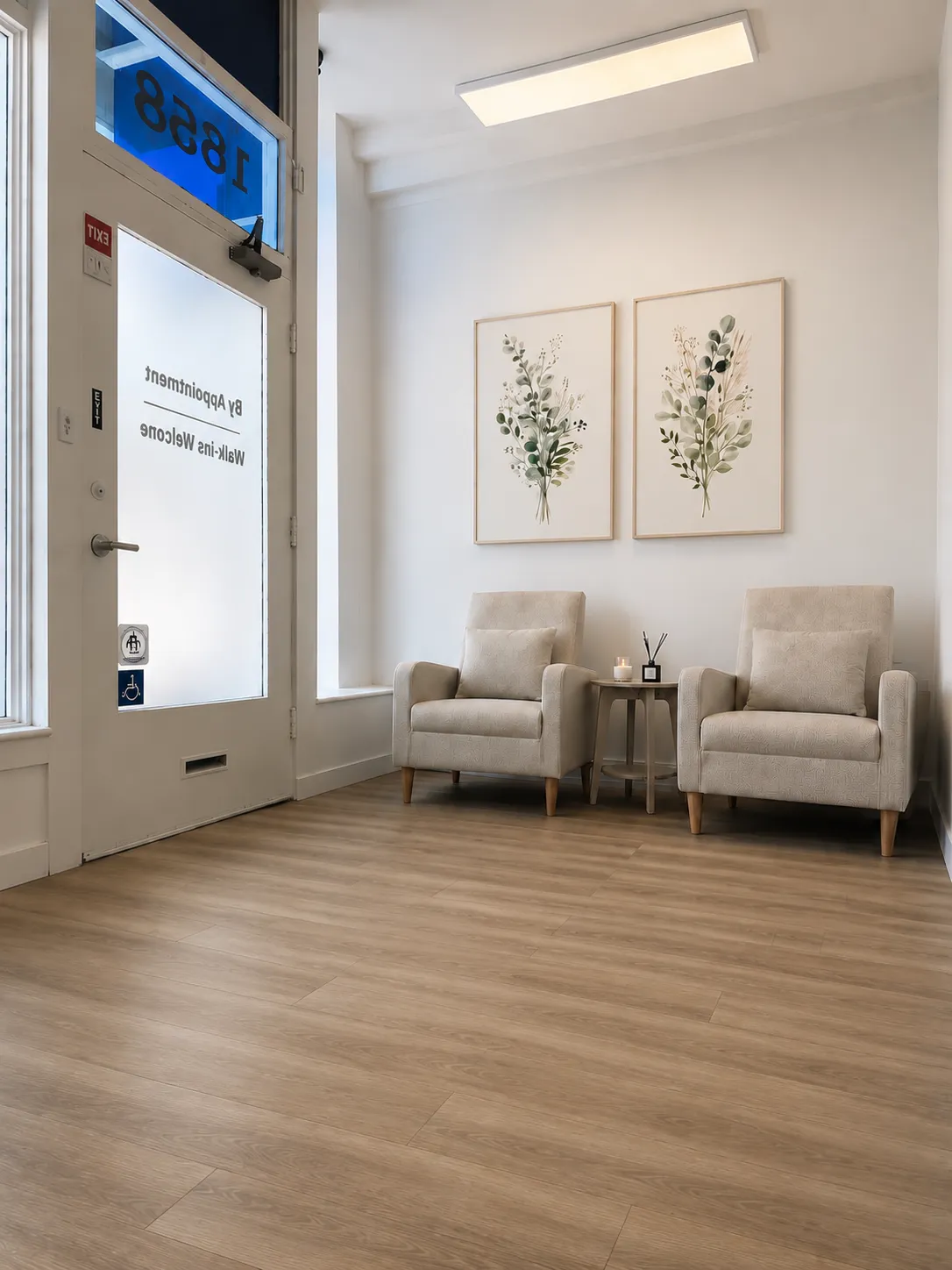 Waiting area at Harbor Wellness Massage with armchairs and botanical prints